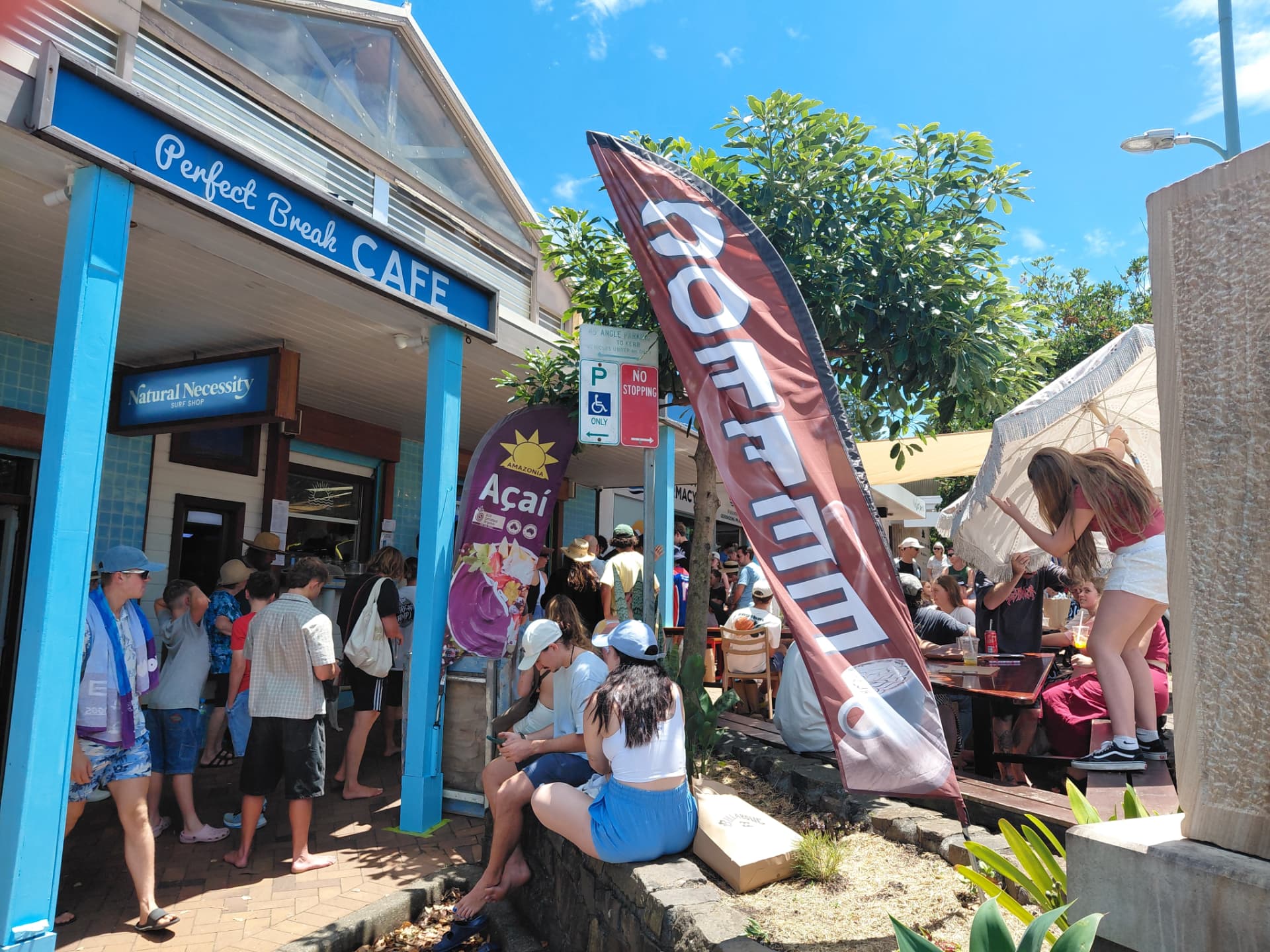 Perfect Break Cafe storefront in Gerringong with guests at the outdoor counter and garden tables